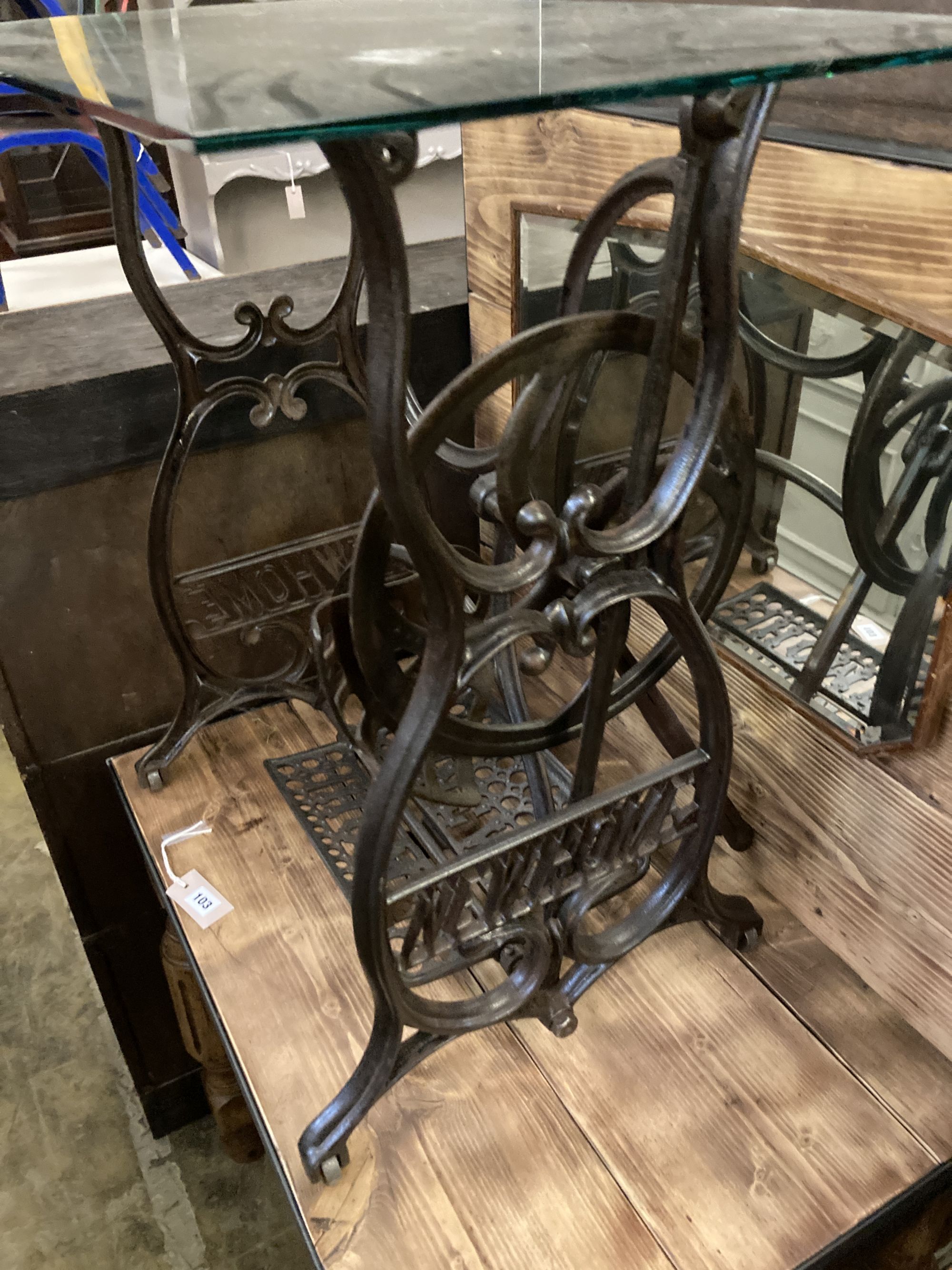 A Victorian Newhome cast iron treadle sewing machine base now as a glass top occasional table, width 75cm, depth 45cm, height 72cm